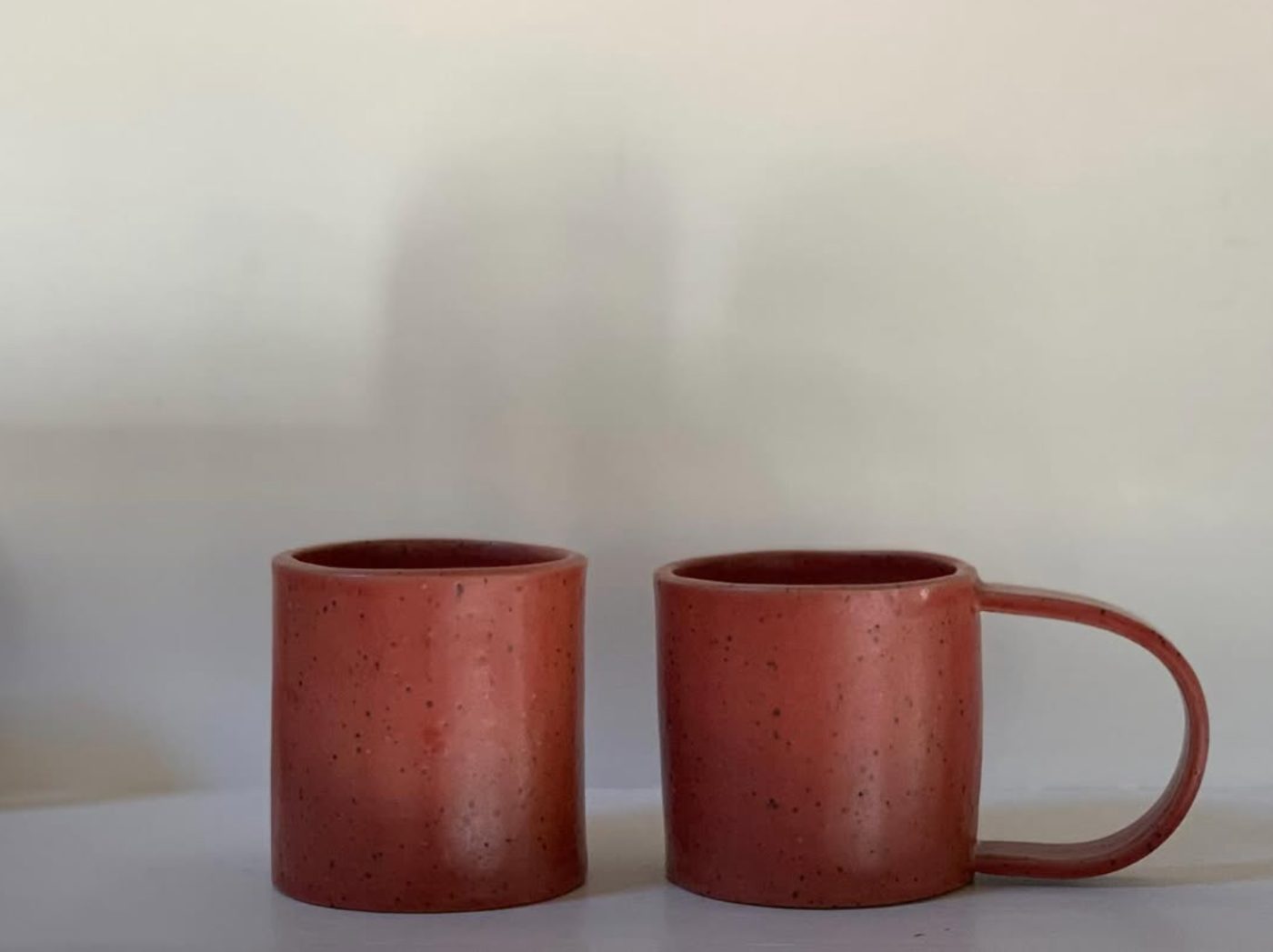 Two terracotta mugs