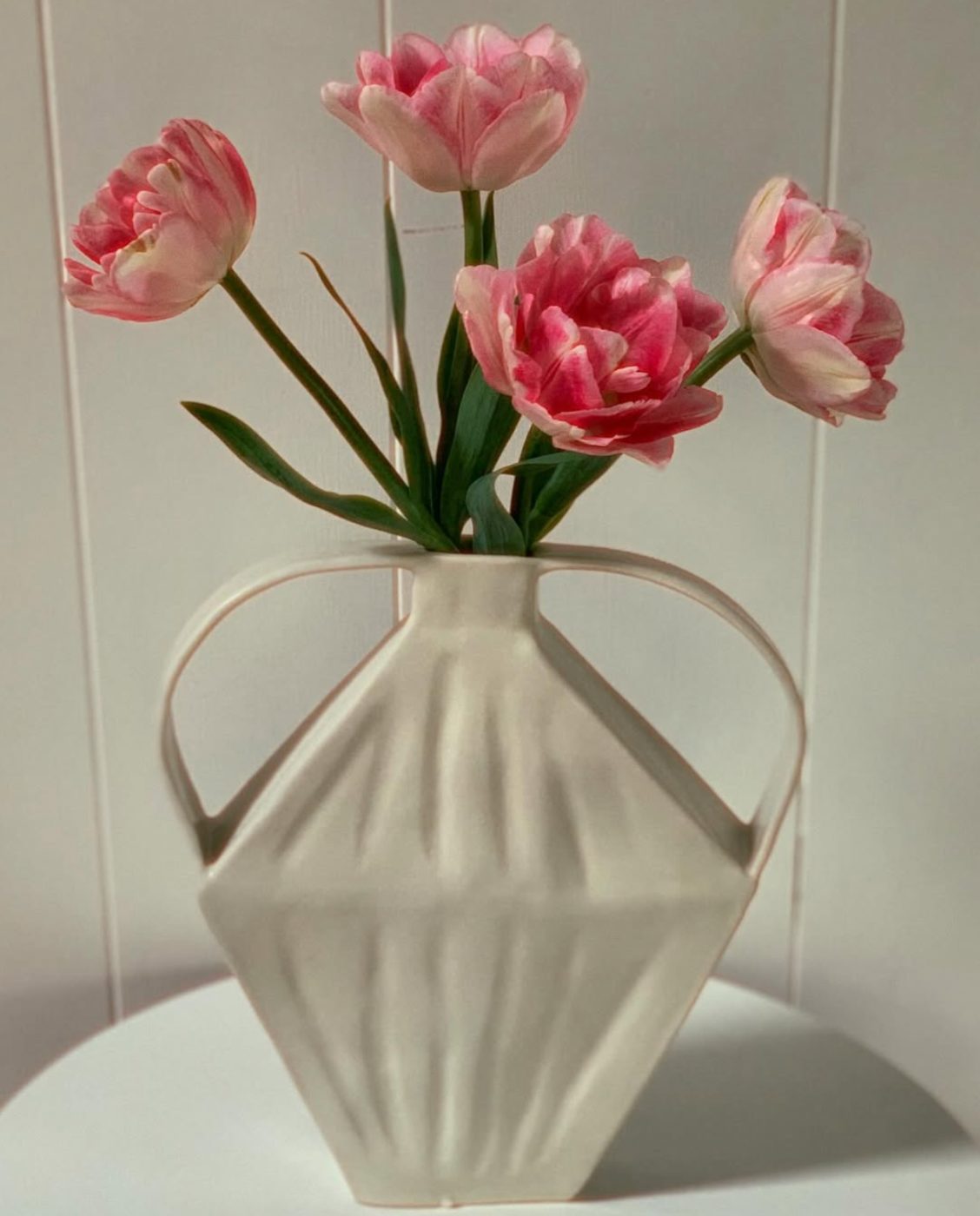 White faceted vase with tulips